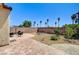 A backyard featuring a brick patio, desert landscaping, a fire pit, and seating for enjoying the outdoors at 6808 Mystic Plain Ct, Las Vegas, NV 89149