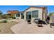 Backyard with a brick patio, desert landscaping, and a seating area with a small bench at 6808 Mystic Plain Ct, Las Vegas, NV 89149