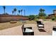 This desert backyard oasis features brick patio, firepit, and seating at 6808 Mystic Plain Ct, Las Vegas, NV 89149