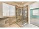 Walk-in shower with glass enclosure and decorative tile surround next to a window with blinds at 6808 Mystic Plain Ct, Las Vegas, NV 89149