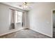 Bedroom features neutral walls, carpet, a window, and a ceiling fan at 6808 Mystic Plain Ct, Las Vegas, NV 89149