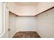 Walk-in closet with carpeted floor, wooden hanging rods, and ample storage space at 6808 Mystic Plain Ct, Las Vegas, NV 89149