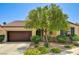 Charming single-story home featuring a well-manicured front yard with lush landscaping and a two-car garage at 6808 Mystic Plain Ct, Las Vegas, NV 89149