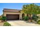 Charming single-story home with a well-manicured front yard, lush landscaping, and a two-car garage at 6808 Mystic Plain Ct, Las Vegas, NV 89149