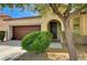 Charming single-story home with manicured landscaping, a two-car garage, and an arched entryway at 6808 Mystic Plain Ct, Las Vegas, NV 89149