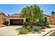 Charming single-story home featuring a well-manicured front yard with lush landscaping and a two-car garage at 6808 Mystic Plain Ct, Las Vegas, NV 89149