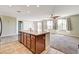 Open kitchen with island and sink boasts lots of natural light and tiled flooring at 6808 Mystic Plain Ct, Las Vegas, NV 89149