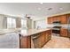 Bright kitchen features an island with sink, stainless steel appliances, and hardwood cabinets at 6808 Mystic Plain Ct, Las Vegas, NV 89149