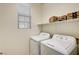 Cozy laundry room with washer and dryer hookups and shelving for storage at 6808 Mystic Plain Ct, Las Vegas, NV 89149