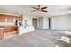 Spacious living room featuring carpet flooring, ceiling fan, and abundant natural light at 6808 Mystic Plain Ct, Las Vegas, NV 89149