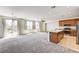 Spacious living room and kitchen area with an island, stainless steel appliances, and lots of natural light at 6808 Mystic Plain Ct, Las Vegas, NV 89149