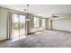Open living room with carpet, ceiling fan, and access to a patio with outdoor space at 6808 Mystic Plain Ct, Las Vegas, NV 89149