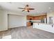 Open-concept living area with carpeting, many windows, and a kitchen with stainless appliances at 6808 Mystic Plain Ct, Las Vegas, NV 89149