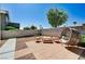 This backyard offers a relaxing outdoor space with a patio area, seating, and privacy wall at 7813 Falconwing Ave, Las Vegas, NV 89131