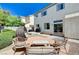 The backyard features patio seating, a barbeque, and lush greenery for a relaxed outdoor lifestyle at 7813 Falconwing Ave, Las Vegas, NV 89131