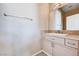 Well-lit powder room featuring a vanity with white countertop, mirror, and tiled backsplash at 7813 Falconwing Ave, Las Vegas, NV 89131