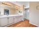 Bright bathroom with dual sinks, large mirrors, and a glass-enclosed shower at 7813 Falconwing Ave, Las Vegas, NV 89131