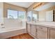 Bathroom with bathtub, tile countertop, and vanity with sink at 7813 Falconwing Ave, Las Vegas, NV 89131