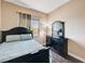 Cozy bedroom featuring a bed, dresser, and window with natural light at 7813 Falconwing Ave, Las Vegas, NV 89131