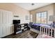 Bright bedroom with two beds, wood floors, and a window with natural light at 7813 Falconwing Ave, Las Vegas, NV 89131