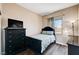 Well-lit bedroom with dark wood floors, a bed, dresser and a window for natural light at 7813 Falconwing Ave, Las Vegas, NV 89131