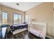 Bright bedroom with two beds, wood floors, and two windows with natural light at 7813 Falconwing Ave, Las Vegas, NV 89131