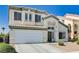 Two-story home featuring a well-manicured lawn and convenient two-car garage at 7813 Falconwing Ave, Las Vegas, NV 89131