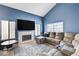 Inviting living room with a fireplace, large windows, and plush seating at 7813 Falconwing Ave, Las Vegas, NV 89131