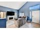 Comfortable living room featuring a fireplace and lots of natural light at 7813 Falconwing Ave, Las Vegas, NV 89131