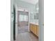 Relaxing bathroom with a vanity, a window, and a doorway view into the main bedroom at 855 N Stephanie St # 2415, Henderson, NV 89014