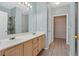 Bright bathroom featuring a double sink vanity, a large mirror, and access to a walk-in closet at 855 N Stephanie St # 2415, Henderson, NV 89014