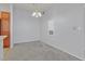 Inviting dining room with neutral walls and carpeting, illuminated by an elegant chandelier and natural light at 855 N Stephanie St # 2415, Henderson, NV 89014