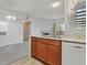 Bright kitchen boasts granite countertops, a stainless steel sink, and a view into an adjacent living room at 855 N Stephanie St # 2415, Henderson, NV 89014