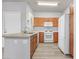 Functional kitchen features wood cabinets, a white refrigerator, and a view of the stove and microwave at 855 N Stephanie St # 2415, Henderson, NV 89014