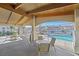 Covered patio seating area adjacent to the sparkling community pool with views of the neighborhood at 855 N Stephanie St # 2415, Henderson, NV 89014