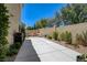 The backyard patio extends to a water feature and lounge area bordered by lush landscaping at 8928 Stafford Springs Dr, Las Vegas, NV 89134
