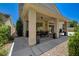 Side view of covered patio that extends to water feature and lounger area in the backyard at 8928 Stafford Springs Dr, Las Vegas, NV 89134