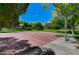 Outdoor basketball court surrounded by trees in a grassy park setting at 8928 Stafford Springs Dr, Las Vegas, NV 89134