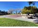 Outdoor basketball court in a park setting surrounded by lush green grass and trees at 8928 Stafford Springs Dr, Las Vegas, NV 89134