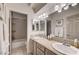 Well-lit bathroom featuring a double sink vanity, neutral color palette, and a shower/tub combo at 8928 Stafford Springs Dr, Las Vegas, NV 89134