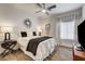 Cozy bedroom with wood floors, ceiling fan, and stylish window coverings at 8928 Stafford Springs Dr, Las Vegas, NV 89134