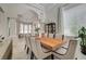 Formal dining room featuring modern chandelier, large windows, and neutral decor for elegant entertaining at 8928 Stafford Springs Dr, Las Vegas, NV 89134