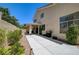 Exterior home view highlighting the covered patio, lush landscaping, and a convenient barbecue area at 8928 Stafford Springs Dr, Las Vegas, NV 89134