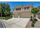 Two-story home with a tile roof, desert landscaping, and an attached two-car garage at 8928 Stafford Springs Dr, Las Vegas, NV 89134