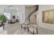 Elegant foyer with curved staircase flows into dining area, ideal for seamless entertaining at 8928 Stafford Springs Dr, Las Vegas, NV 89134