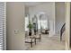 Open-concept foyer features neutral paint colors, staircase, and elegant dining area at 8928 Stafford Springs Dr, Las Vegas, NV 89134