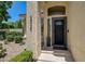 Inviting front door with decorative glass, textured column, and manicured landscaping at 8928 Stafford Springs Dr, Las Vegas, NV 89134