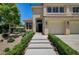 Welcoming front entrance with a beautiful walkway lined with manicured bushes and flower accents at 8928 Stafford Springs Dr, Las Vegas, NV 89134