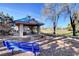 Park gazebo with blue roof and stone pillars featuring seating and scenic park views at 8928 Stafford Springs Dr, Las Vegas, NV 89134