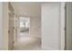 Hallway featuring neutral tones, tiled flooring and passage to living space at 8928 Stafford Springs Dr, Las Vegas, NV 89134